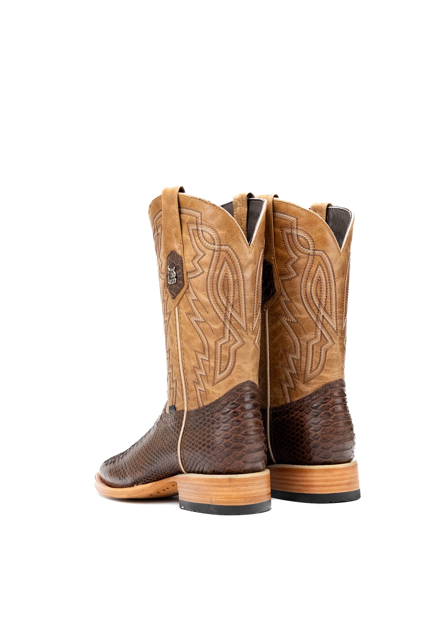 Back view of the renegade pythoncowboy boot in brown featuring a python print vamp, flame embroidery on a dark shaft, square toe, leather sole, and rubber heel.