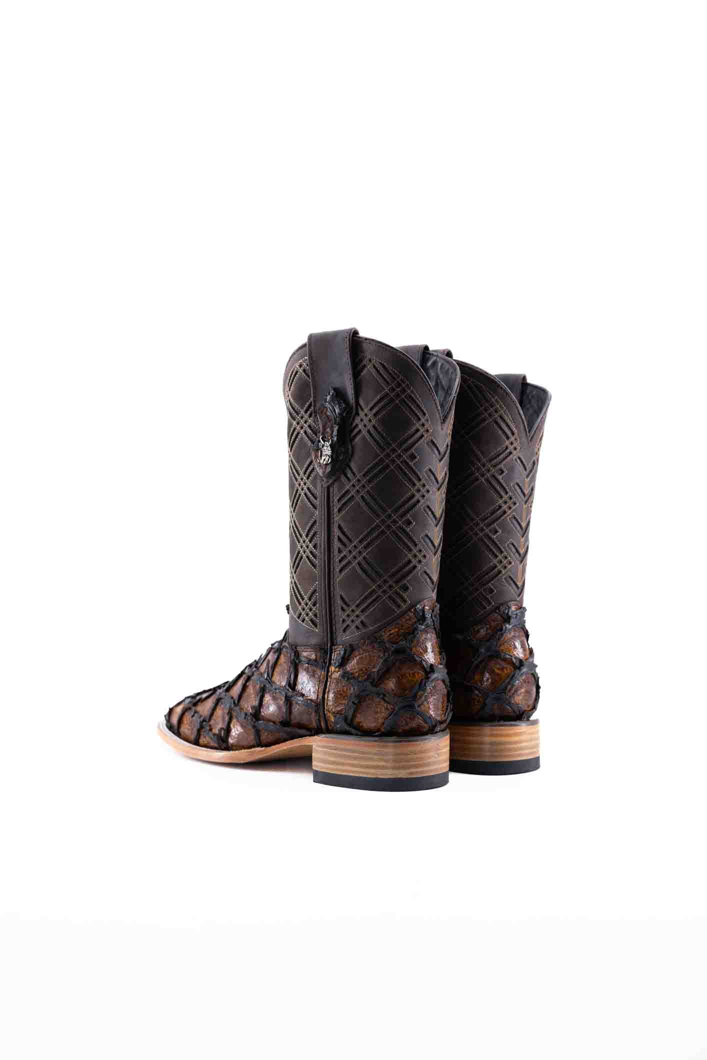 The Bradley boot features a honey Pirarucu fish print vamp, a brown leather shaft with a laser-cut pattern, a square toe, and a natural-tone sole.