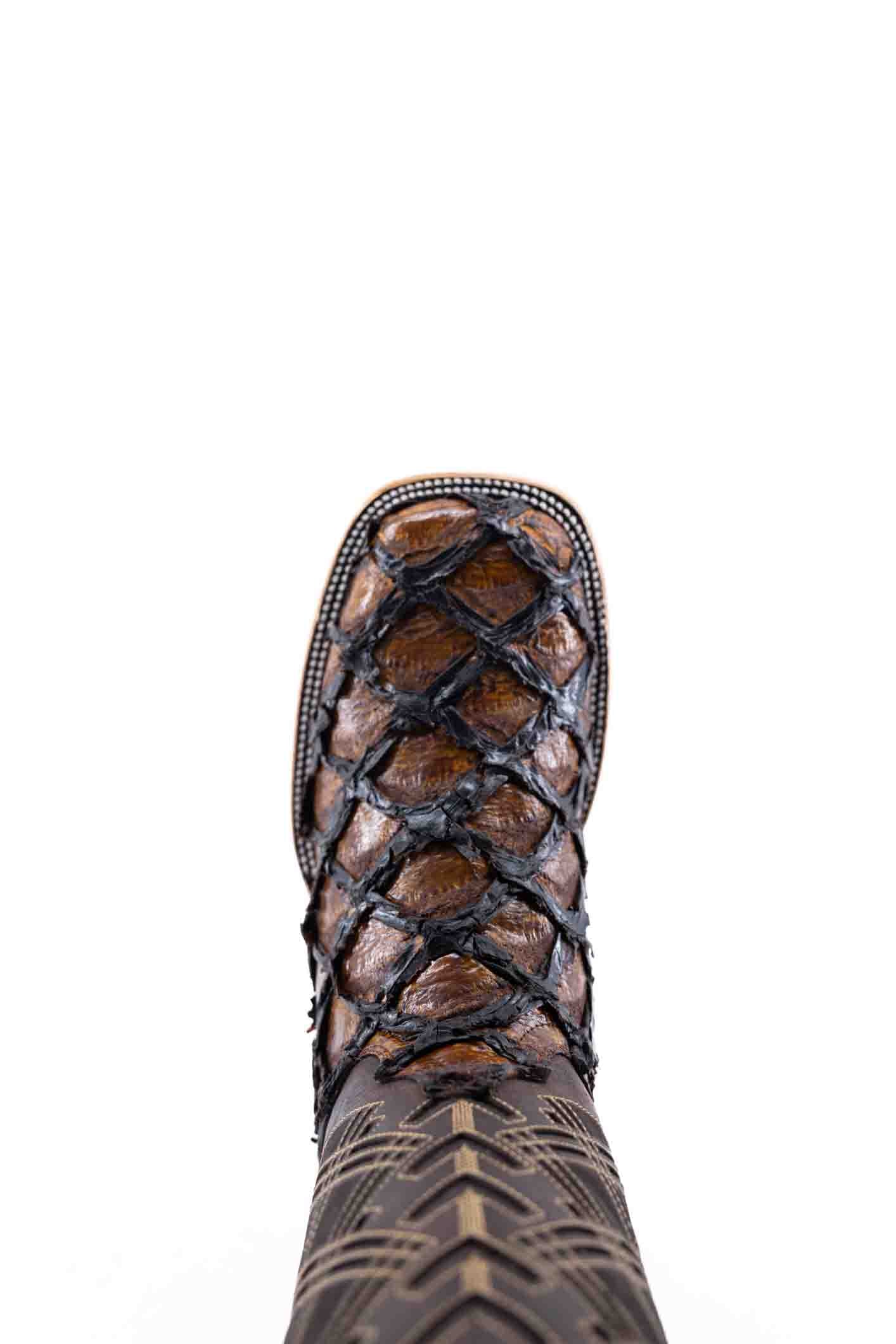 The Bradley boot features a honey Pirarucu fish print vamp, a brown leather shaft with a laser-cut pattern, a square toe, and a natural-tone sole.