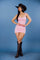 Pink mini dress features cap sleeves, a scoop neckline, and an open-back design accented by a large satin bow at the lower back.