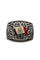 Close up of a silver metal belt buckle with scrollwork and a Mexican flag in the middle.