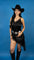 Close-up view of a woman wearing a black, lace mini dress with spaghetti straps and an asymmetrical hem.