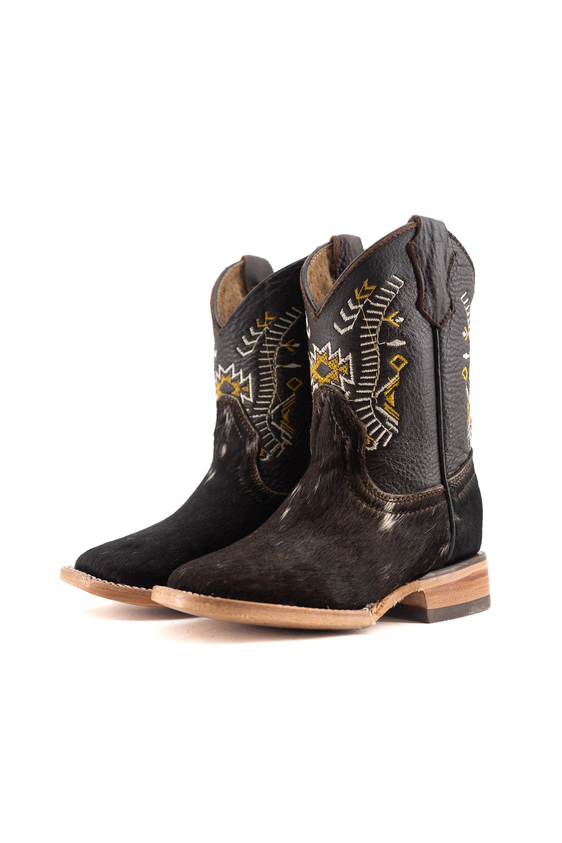 Pair of black and brown cowboy boots with intricate designs on a white background