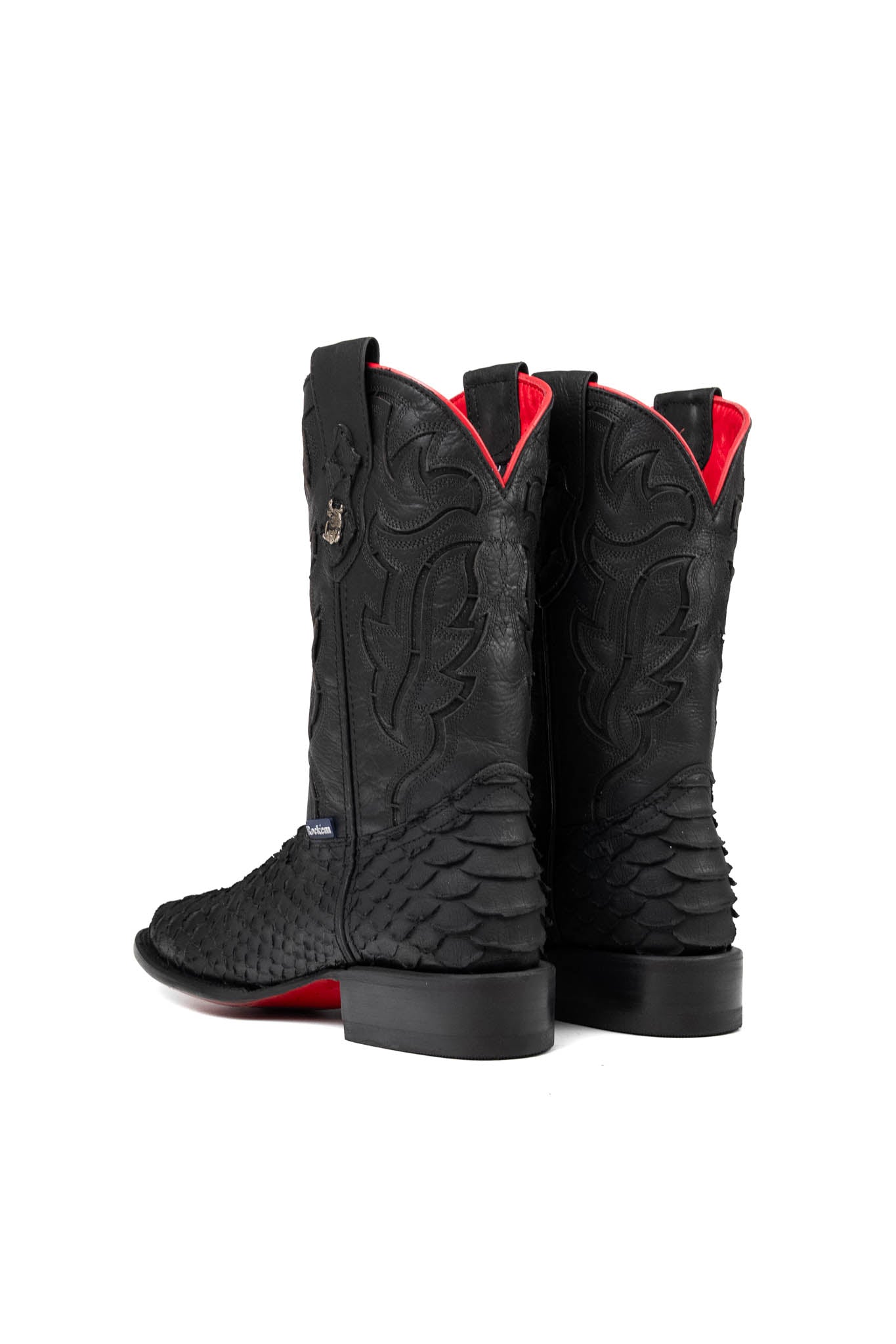 The Viper cowboy boots feature a black python-textured vamp, black stitched leather shaft, square toe, red bottom, black sole, rubber heel, and Rock'em bull emblem.
