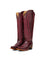 Pair of burgundy cowboy boots on a white background
