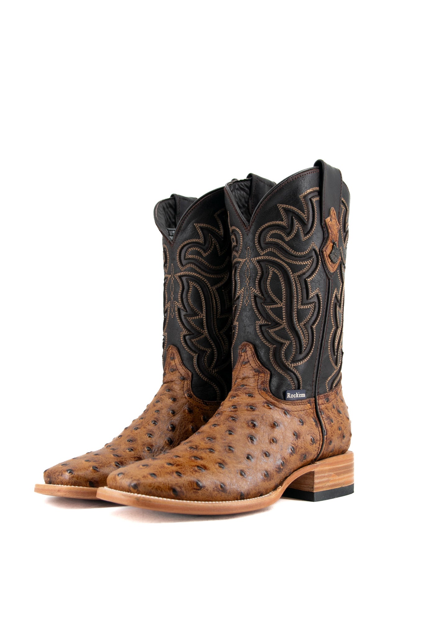 The Bruce ostrich cowboy boot in maple features a bumpy vamp, flame inlays on a dark shaft, square toe, leather sole, and rubber heel.