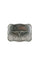 Close up shot of a silver metal belt buckle with rope edges and floral scrollwork with a long horn in the middle.