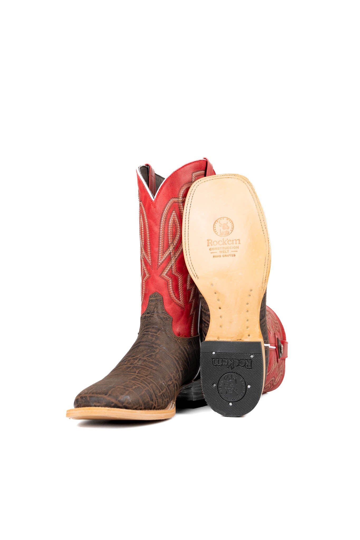 View of the Renegate Elephant cowboy boots crafted from genuine leather, featuring a square toe, brown elephant print vamp, red shaft with embroidered shaft, leather sole and rubber heel.