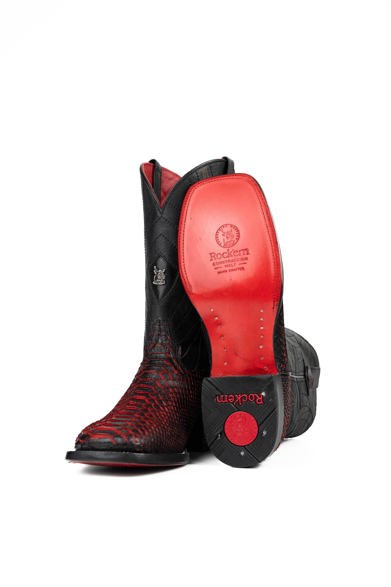 View of the Python Exotic Cowboy Boots in Red/Black. Made from genuine leather, red and black python-print vamp, square toe, and an embroidered shaft. Finished with a durable rubber heel and a red sole.