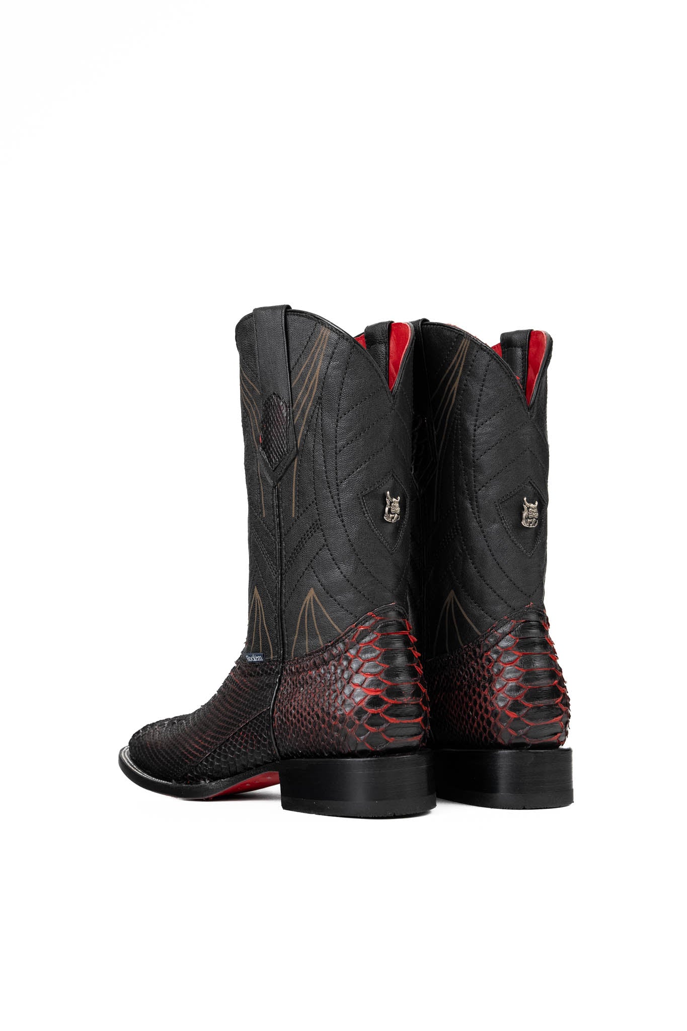 Back of the Python Exotic Cowboy Boots in Red/Black. Made from genuine leather, red and black python-print vamp, square toe, and an embroidered shaft. Finished with a durable rubber heel and a red sole.