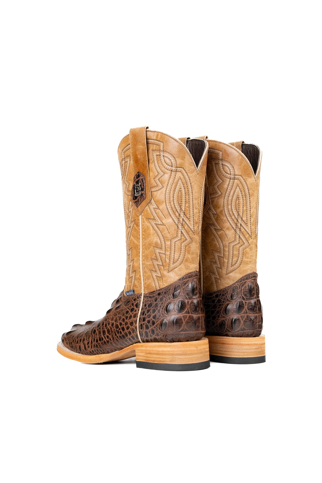 Back of the Renegate Giant Alligator Cowboy Boot in brown made of genuine leather, featuring a square toe, brown caiman print vamp, tan shaft with embroidery, leather sole and rubber heel. 
