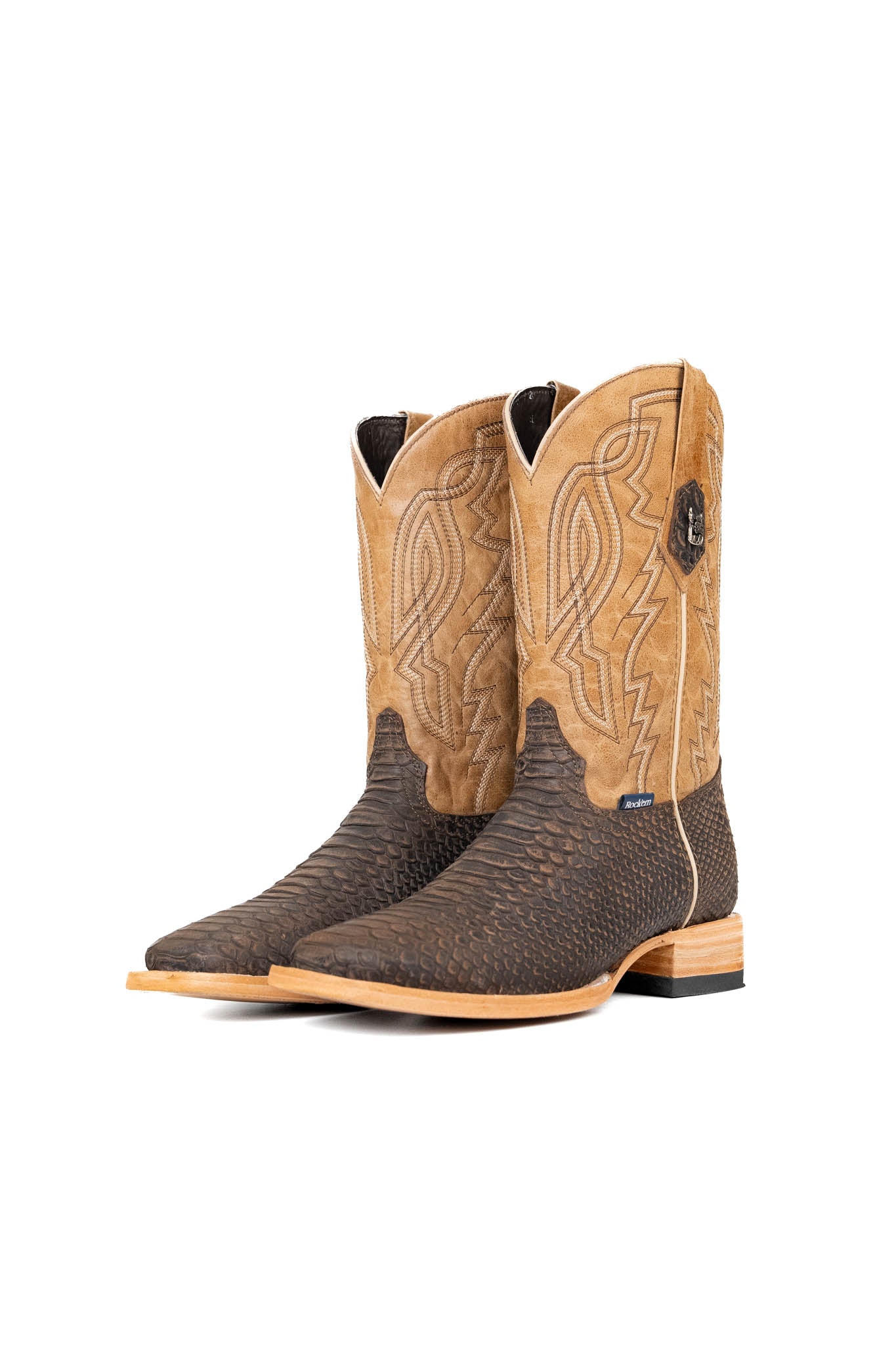 The Renegate Python boot in matte brown features brown Pirarucu fish print vamp, tan leather shaft with embroidery, a square toe, and leather sole. 