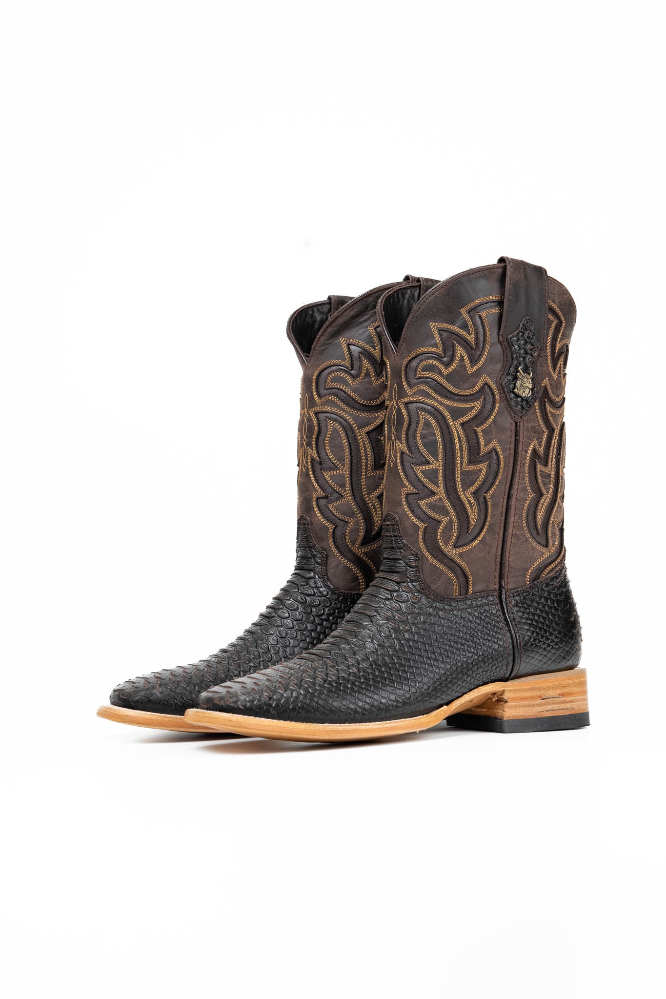 The Bruce boots feature a brown coca Python print vamp, a rugged brown leather shaft with bold inlays, a square toe, pull straps, and a sturdy Western sole.