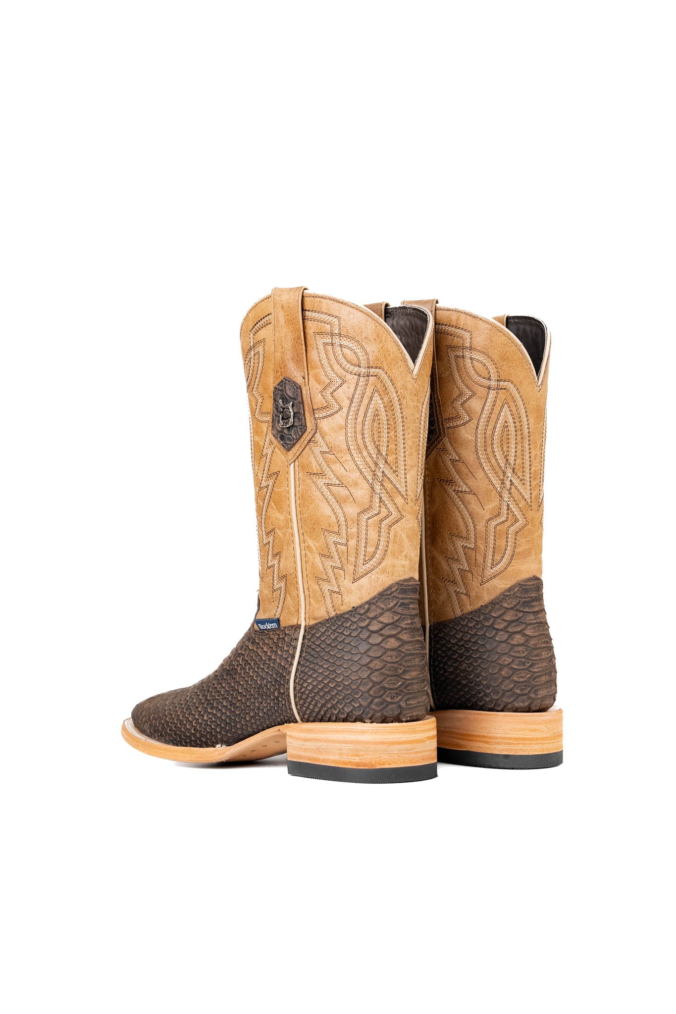 Back view of the Renegate Python boot in matte brown features brown Pirarucu fish print vamp, tan leather shaft with embroidery, a square toe, and leather sole. 