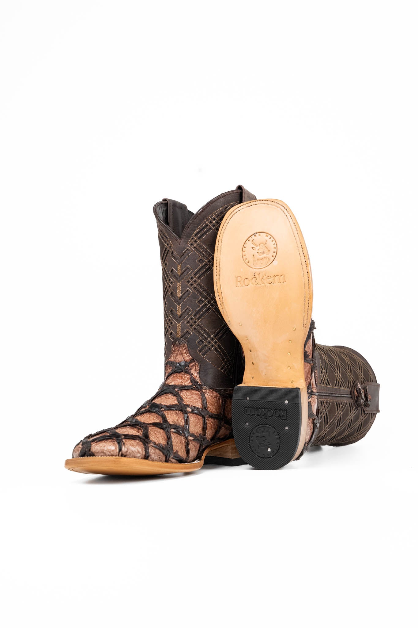 The Bradley boot features an oryx Pirarucu fish print vamp, a brown leather shaft with a laser-cut pattern, a square toe, and a natural-tone sole.