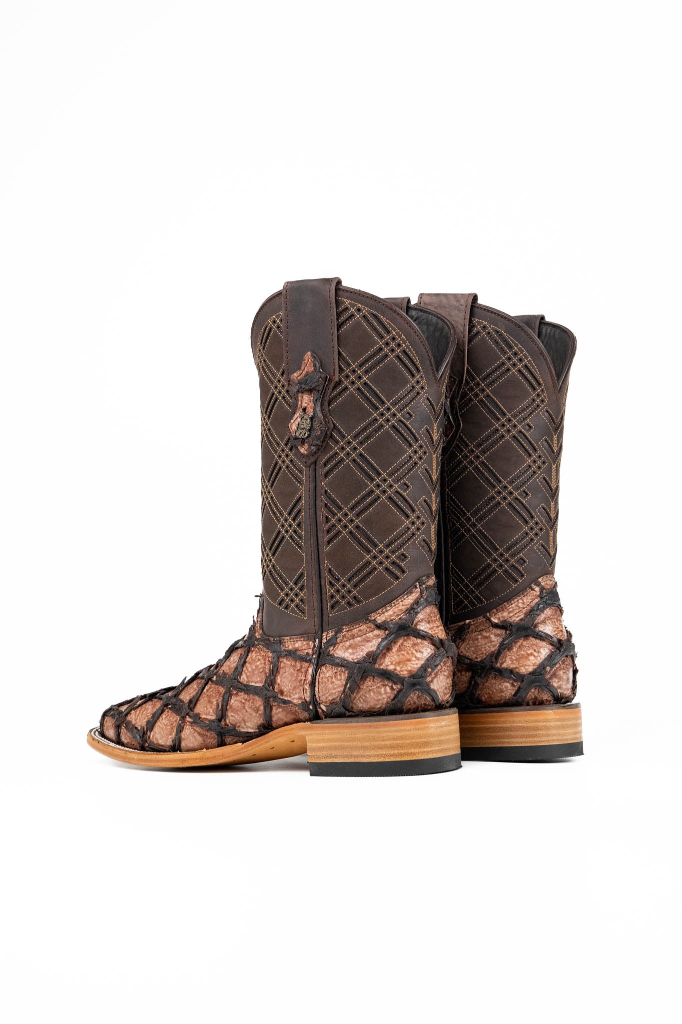 The Bradley boot features an oryx Pirarucu fish print vamp, a brown leather shaft with a laser-cut pattern, a square toe, and a natural-tone sole.