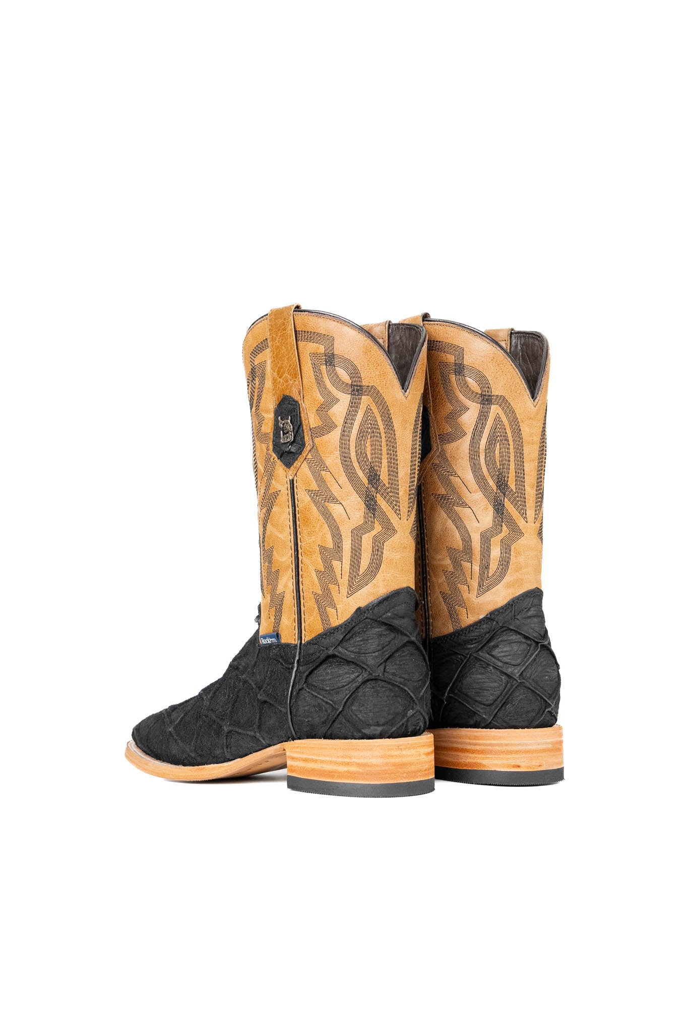 Back view of the Renegate Big Bass Pirarucu boot in matte black features a black Pirarucu fish print vamp, a tan leather shaft with embroidery, a square toe, and leather sole.