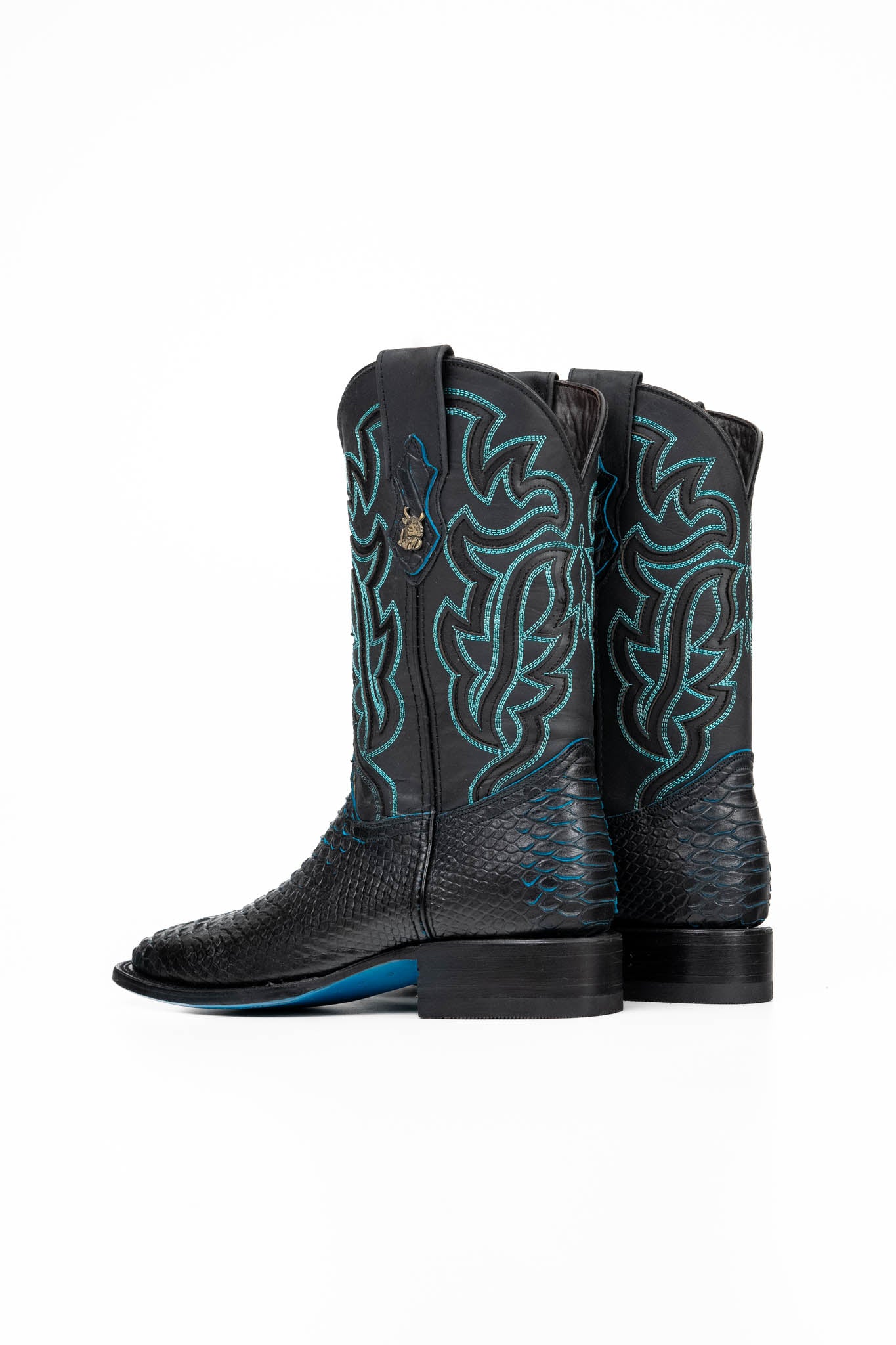 The Black Bruce cowboy boots are genuine leather, featuring a square toe, Python print vamp, turquoise embroidery shaft, rubber heel, and a turquoise sole. 