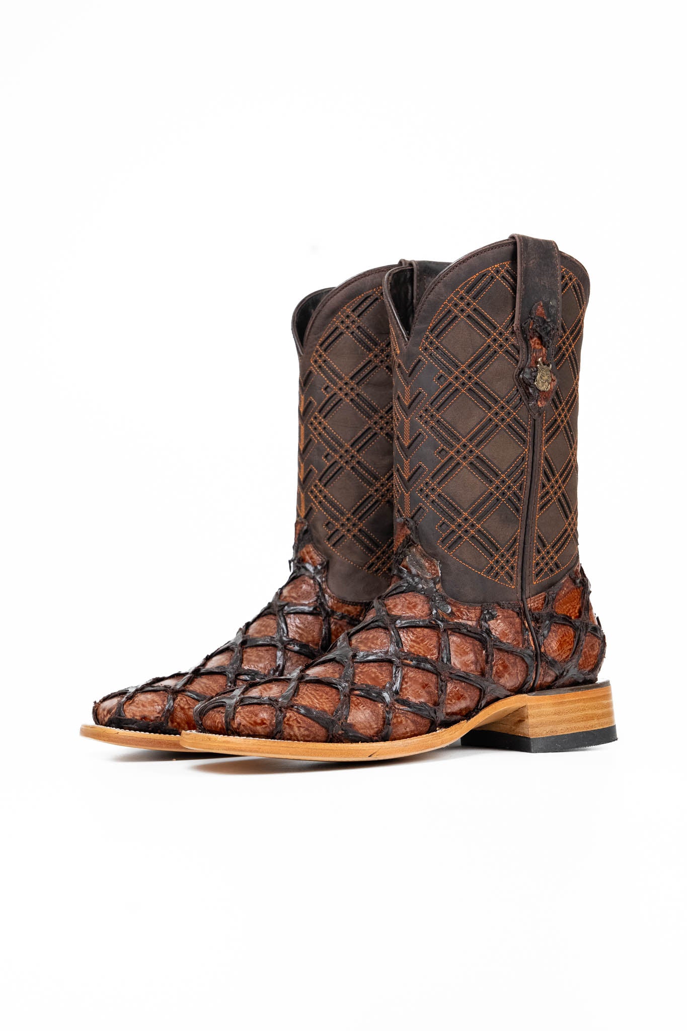 The Bradley boot features a cognac Pirarucu fish print vamp, a brown leather shaft with a laser-cut pattern, a square toe, and a natural-tone sole.