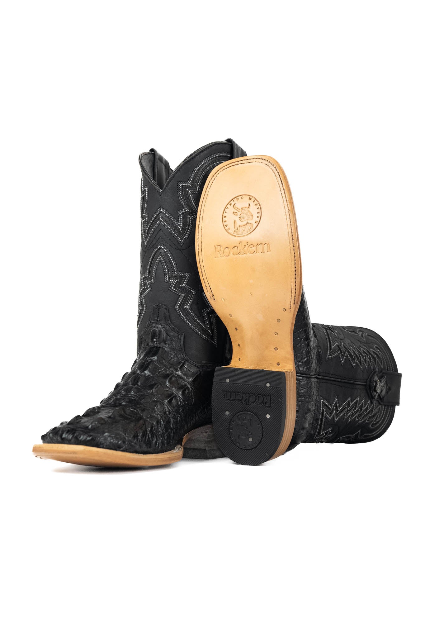 The Jameson boots have a black caiman-textured vamp, a black shaft with bold zigzag stitching, a square toe, and a sturdy leather sole with a rubber heel.