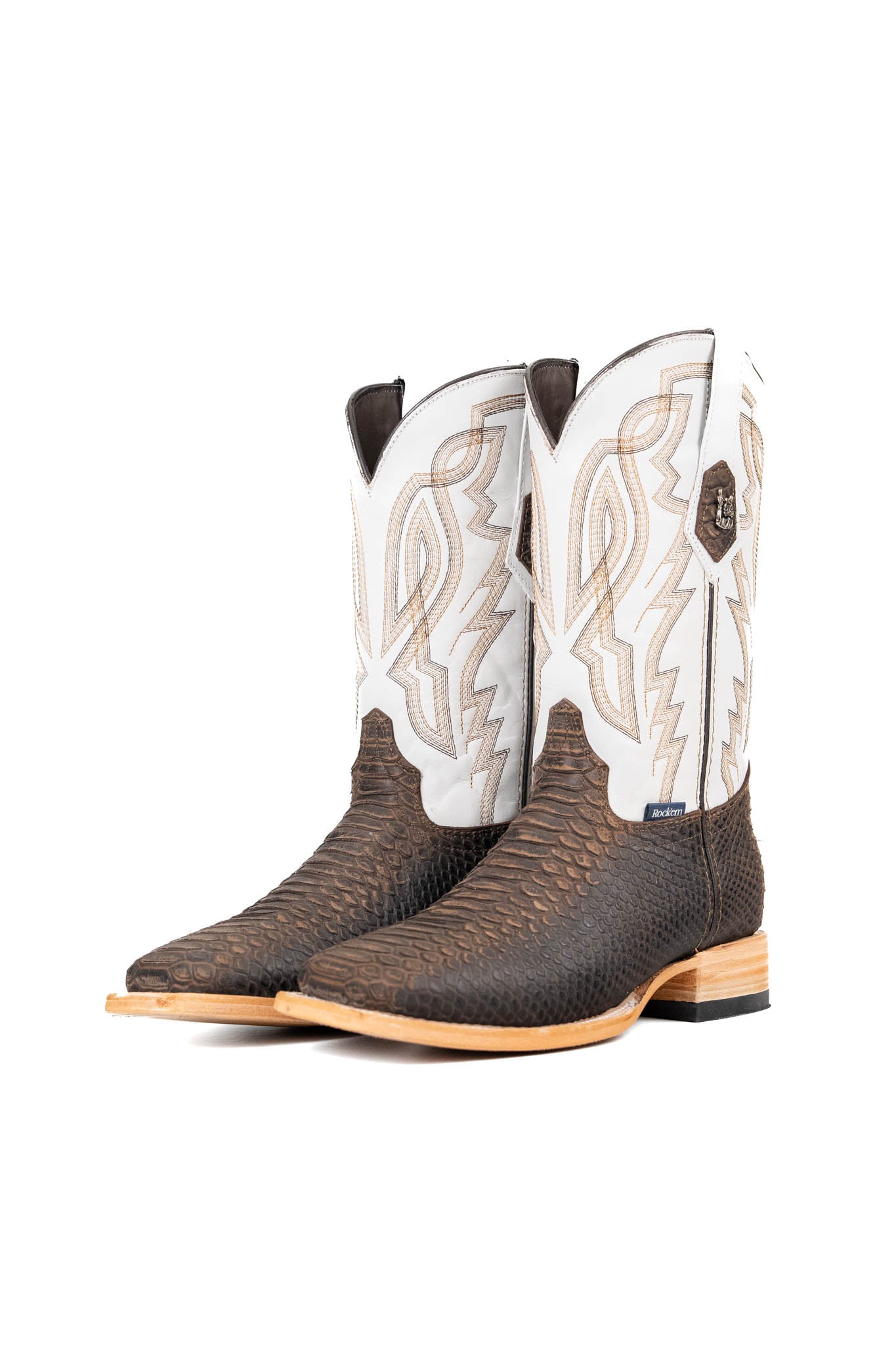 The Renegate Python boot in rustic brown featuring a brown pirarucu fish print vamp, white leather shaft with embroidery, a square toe, and leather sole. 