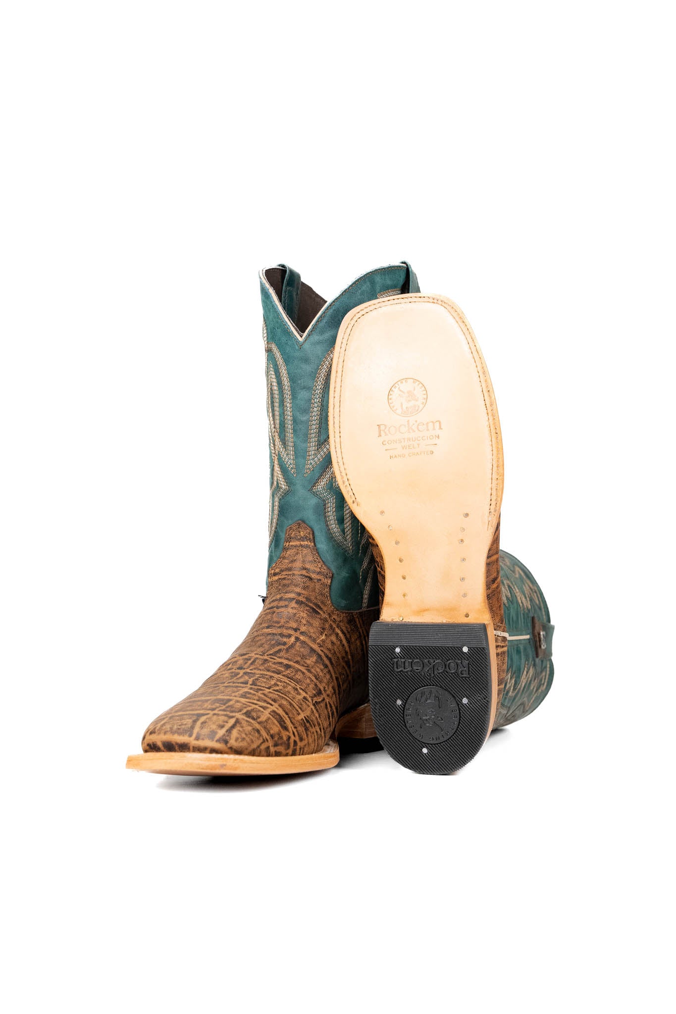 Side view of the Renegate Elephant cowboy boots crafted from genuine leather, featuring a square toe, brown elephant print vamp, teal shaft with embroidered shaft, leather sole and rubber heel.