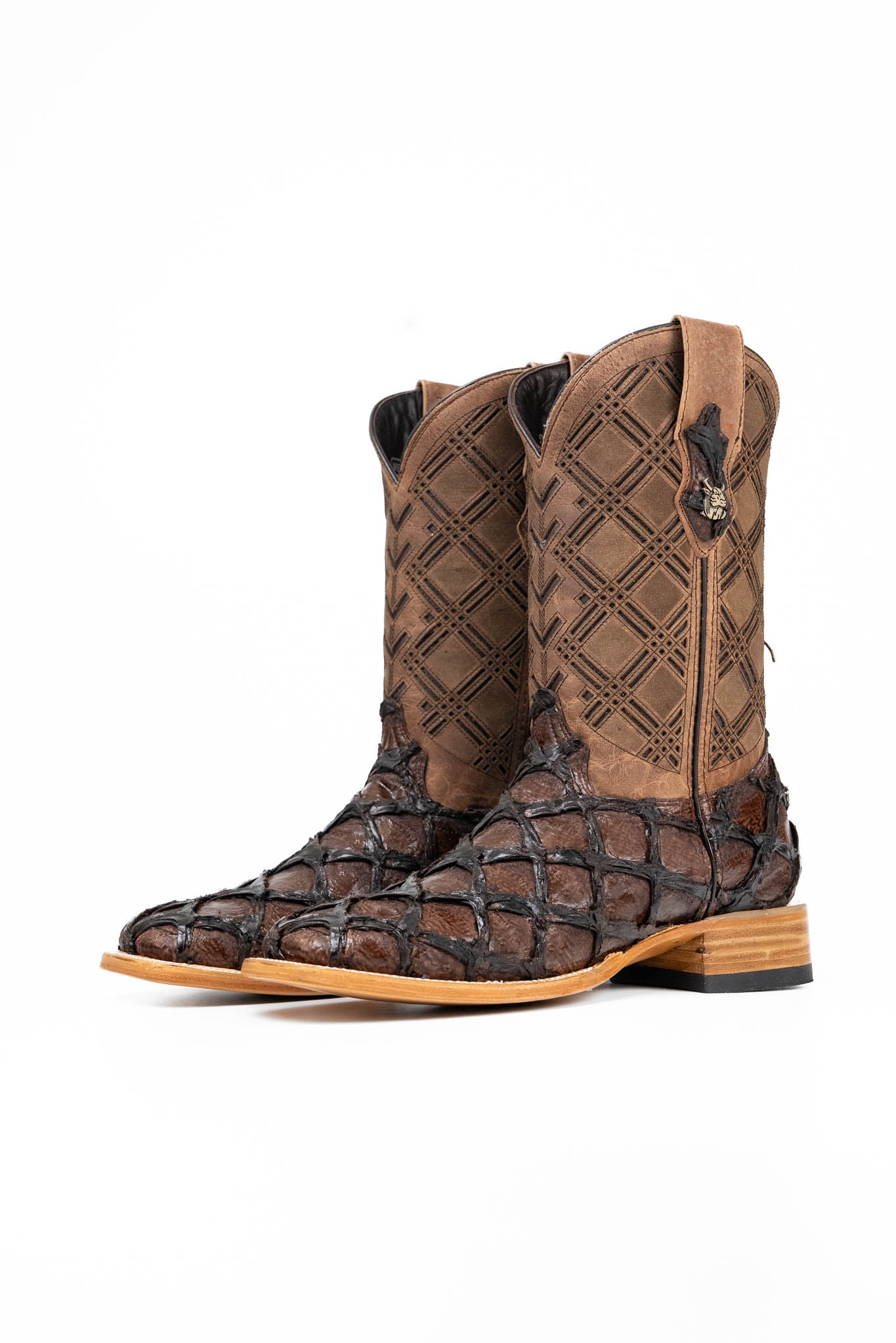 The Bradley boot features a brown Pirarucu fish print vamp, a brown leather shaft with a laser-cut pattern, a square toe, and a natural-tone sole.