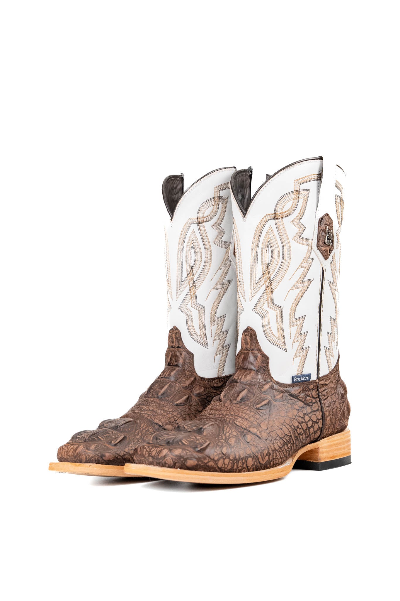 The Renegate Giant Alligator Cowboy Boot in rustic brown made of genuine leather, featuring a square toe, brown caiman print vamp, white shaft with embroidery, and rubber heel. 