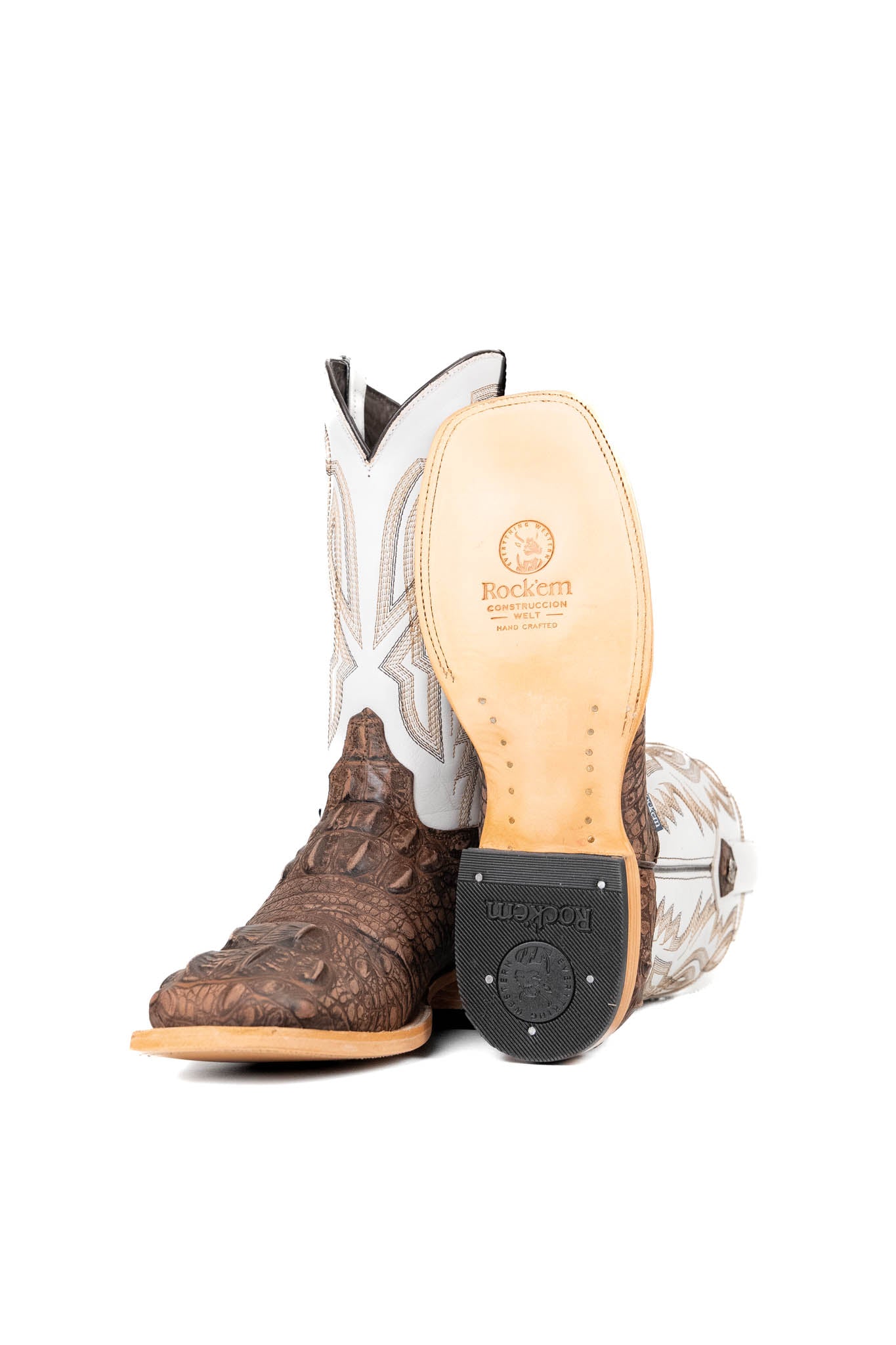 View of the Renegate Giant Alligator Cowboy Boot in rustic brown made of genuine leather, featuring a square toe, brown caiman print vamp, white shaft with embroidery, leather sole and rubber heel. 