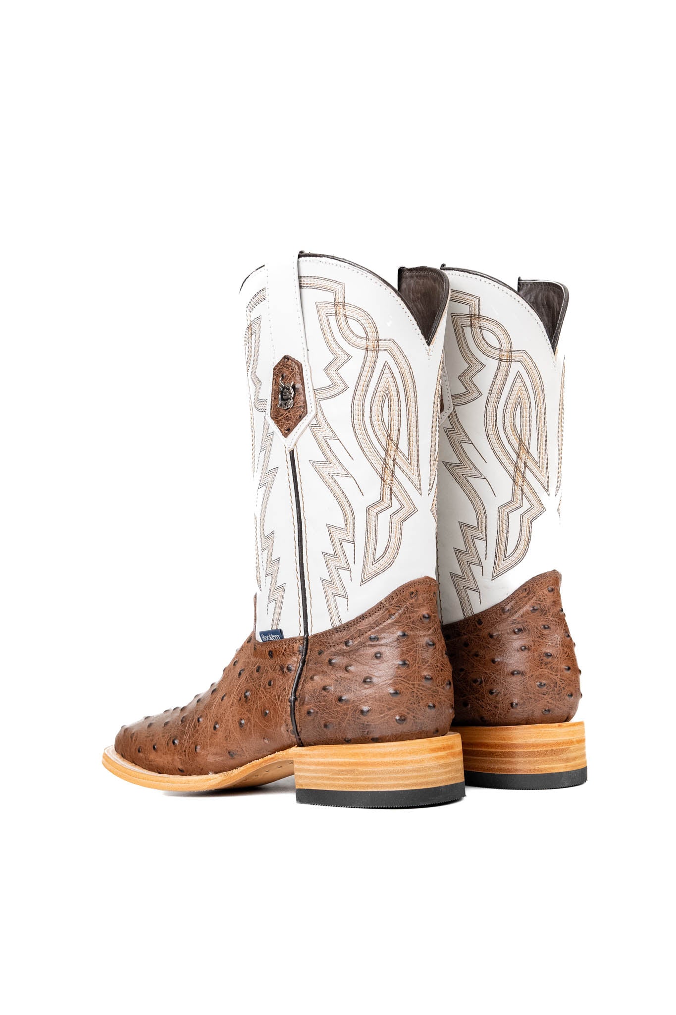 Back view of the Renegate Ostrich Square Toe has a bumpy brown ostrich vamp, white shaft with embroidery pattern, a square toe, and a sturdy leather sole with a rubber heel.